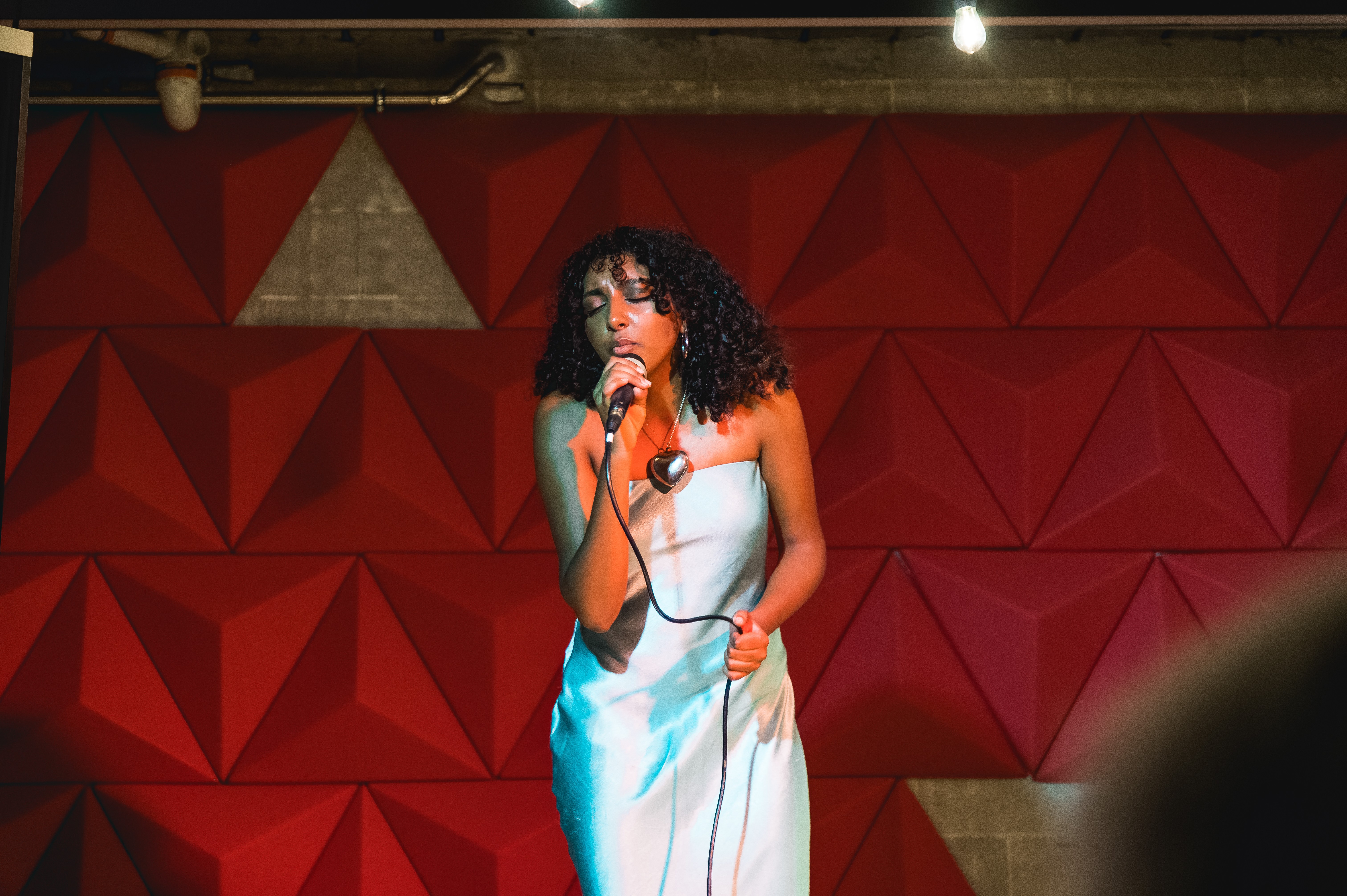 Rangatahi performer on stage under warm lights