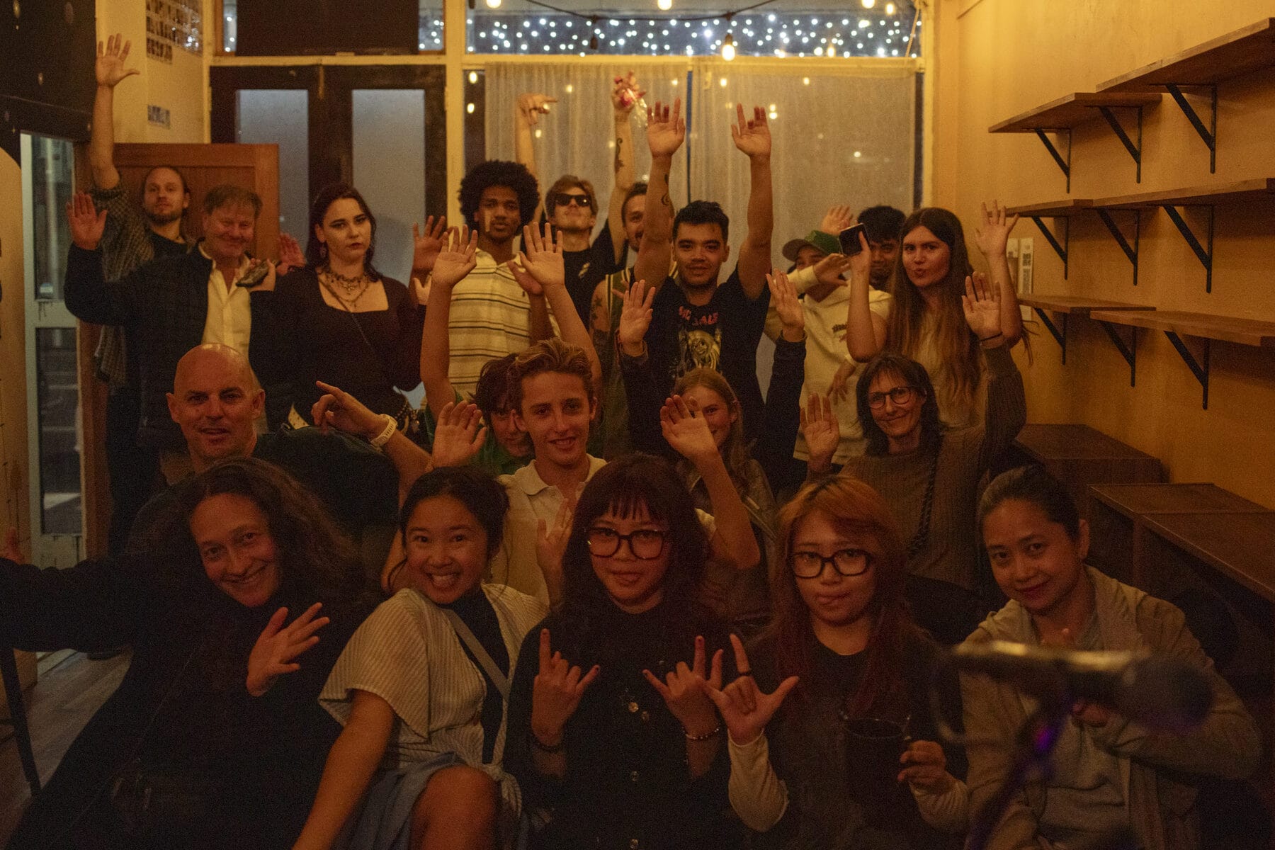 Performers and crew cheering together at the end of the night