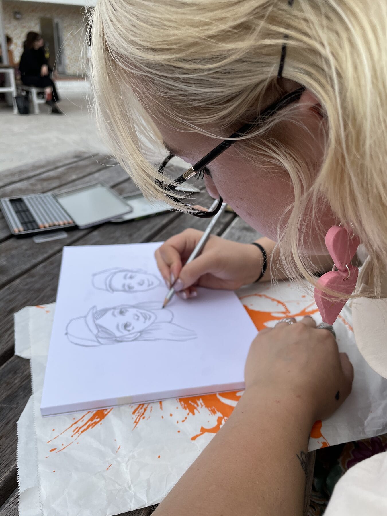 A young artist sketching a portrait in pencil