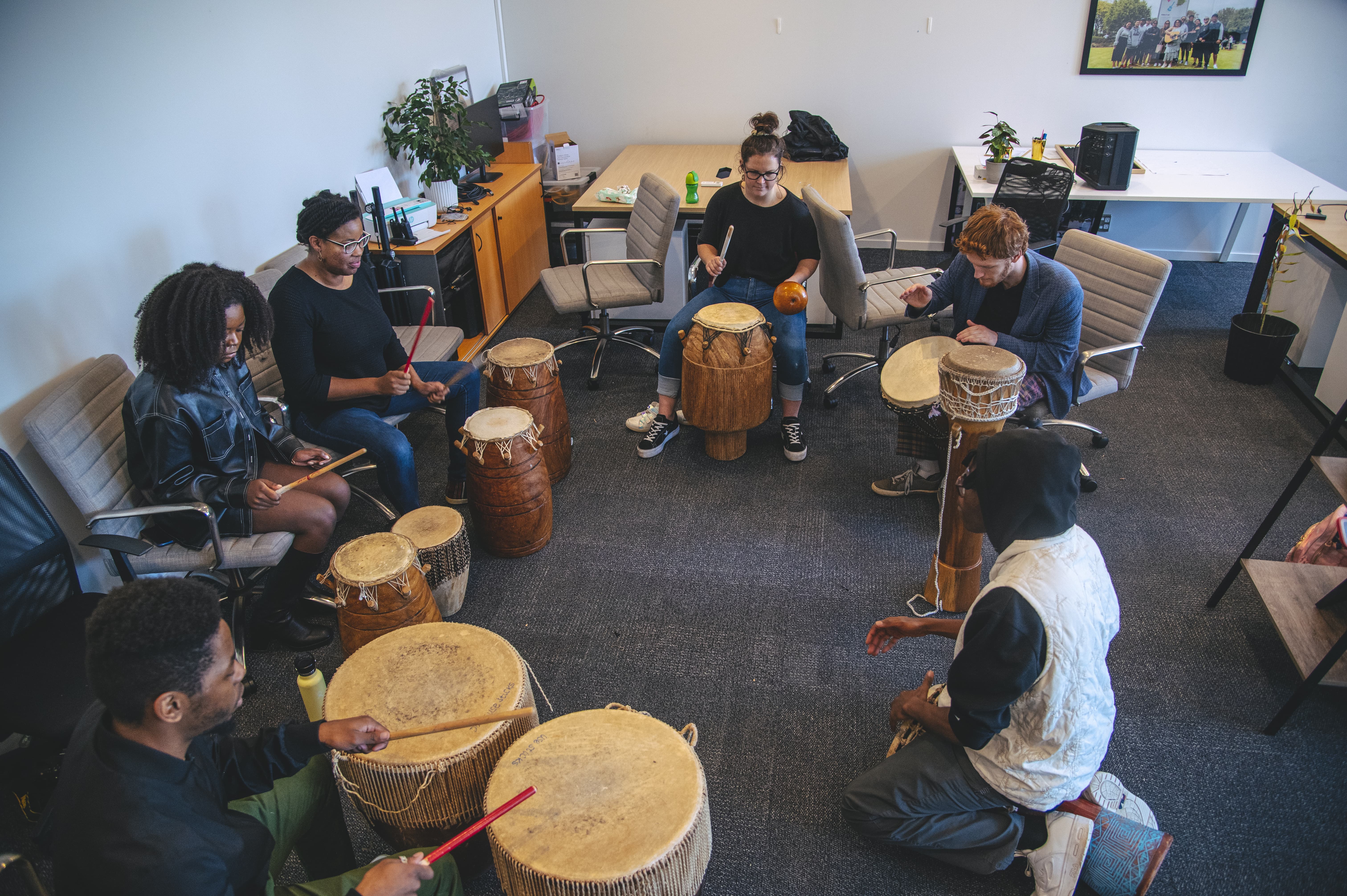 Rangatahi drumming together at a wānanga