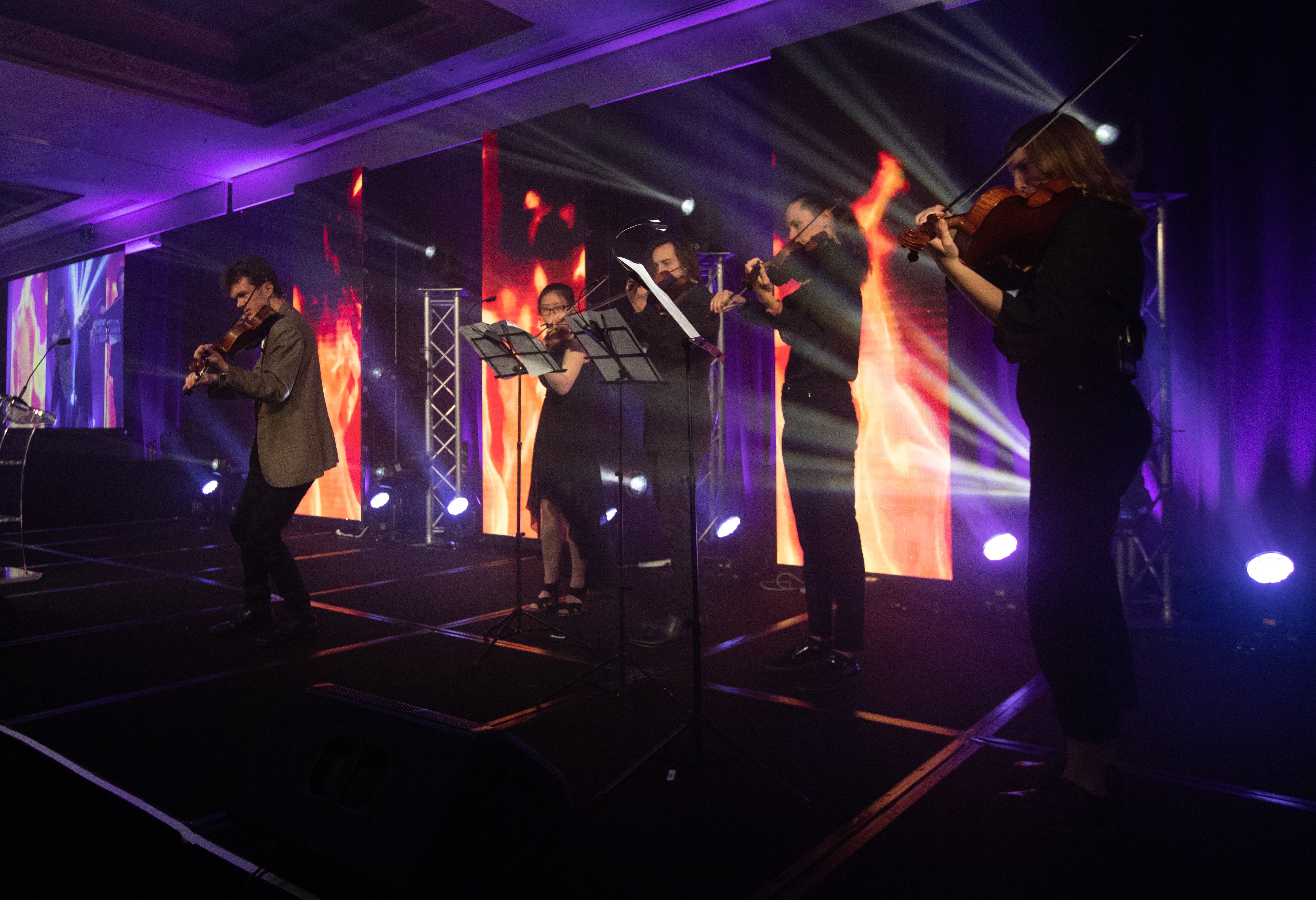 Young string players performing at a gala